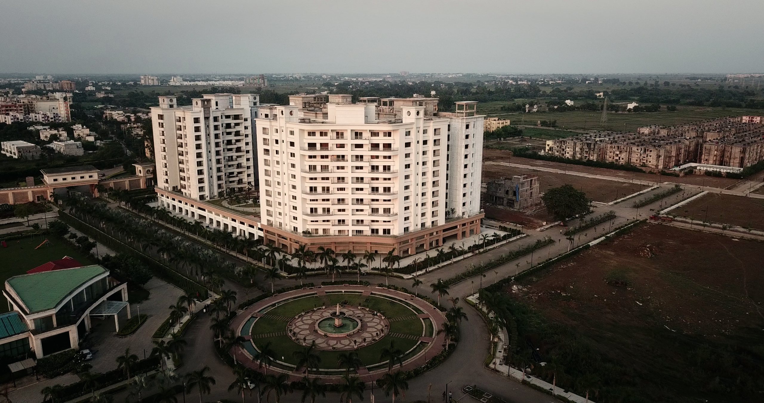 Arshiya SkyVillas at dusk, beside the main centre fountain of Anandam World City